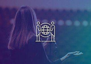 GSIS 2025 Conference – Visual Spotlight Woman seen from behind gesturing, with a white graphic of two figures holding a globe with a network pattern in the center.
